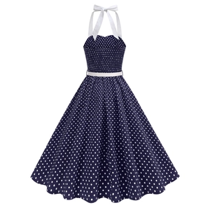 Detail of retro polka dot dress featuring halter neck tie and white decorative bow