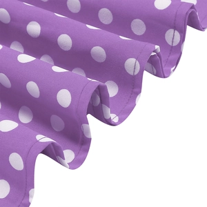 Detailed macro view of purple polka dot fabric and double-stitched hem on the vintage dress