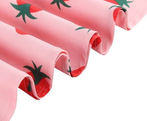 Detail of pink vintage dress showing strawberry floral pattern and pleated hem fabric