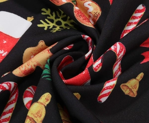 Macro detail of Christmas dress fabric with candy canes and gingerbread man prints