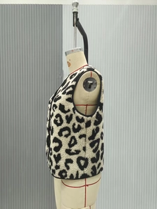Detailed side view of leopard print faux shearling vest with black contrast piping