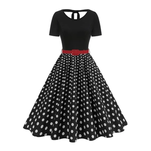 Retro polka dot dress with short sleeves, black bodice and a red waist belt