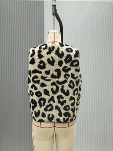 Close-up of leopard print faux fur vest showing plush texture and black piping on back