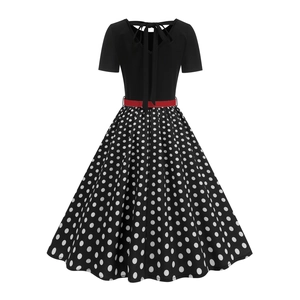 Detail view of a vintage polka dot dress with back bow tie and red waist belt