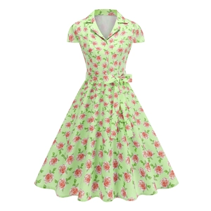 Detail of green floral dress featuring lapel collar, button-down front, and waist tie
