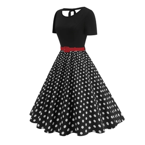 Retro black polka dot dress with short sleeves and red belt in 1950s Audrey Hepburn style