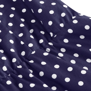 Macro shot of navy blue polka dot fabric texture with smooth woven surface detail