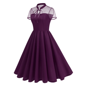 Detail of dark purple vintage dress with black polka dot mesh neckline and bow tie