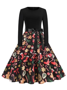 Detail view of high-waisted Christmas dress with festive gingerbread and snowflake prints