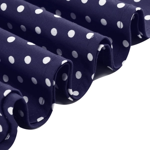 Detailed view of navy blue and white polka dot fabric with pleated ruffle texture
