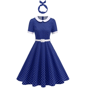 Detail of vintage navy polka dot dress with white collar, belt and matching headband