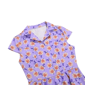 Detail of vintage floral print dress featuring lapel collar and pearlescent buttons