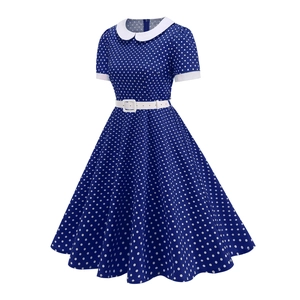 Detail view of vintage polka dot dress featuring white Peter Pan collar and waist belt