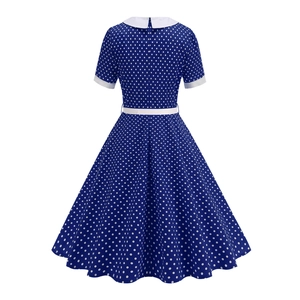 Back view of a vintage blue polka dot dress with white Peter Pan collar and waist belt