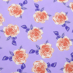 Close-up of lilac floral fabric featuring orange roses and navy leaves with twill texture