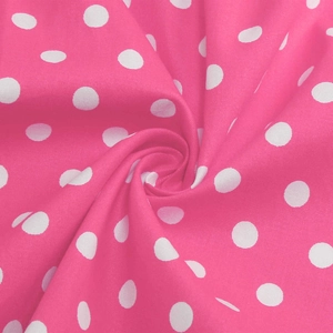 Detailed macro view of pink polka dot fabric texture with soft pleated draping