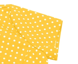 Detail of yellow polka dot short sleeve shirt showing stitching on shoulder and cuff