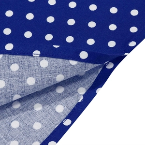 Detail view showing professional stitching on navy blue polka dot cotton dress fabric