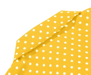 Detailed close-up of yellow fabric with white polka dots and sharp shirt collar design