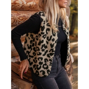 Women's leopard print sherpa vest with black trim styled in an outdoor autumn forest