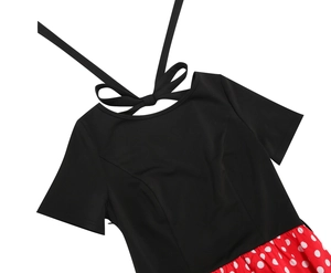 Detailed view of vintage rockabilly dress featuring a back bow tie and red polka dot skirt