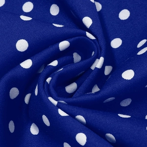 Close-up of royal blue fabric with white polka dots showing detailed woven texture