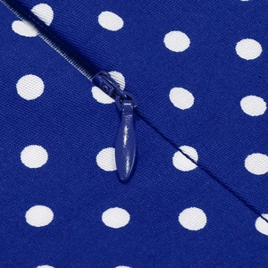 Close-up of the hidden zipper detail on a navy blue polka dot Hepburn style dress