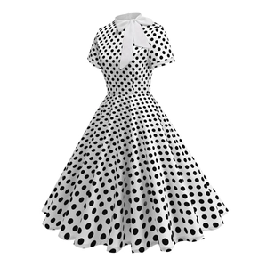 Detail of vintage polka dot dress featuring a white bow tie and stylish standing collar
