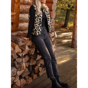 Women's leopard print plush vest styled with black knit top and dark grey jeans