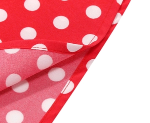 Detail of red and white polka dot fabric with high-quality stitching on dress hem