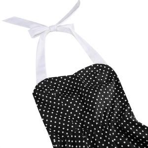 Detailed view of polka dot dress featuring a halter neck and chic bow accent