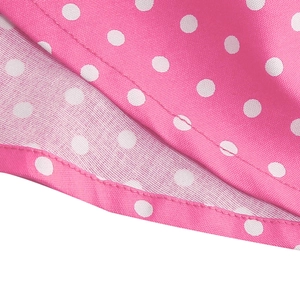 Detail of pink polka dot fabric showing uniform stitching and premium smooth texture