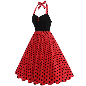 Detail of vintage halter dress showing black heart-shaped neckline and red polka dot skirt