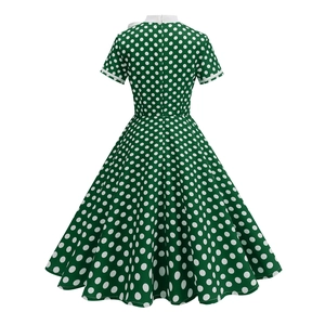 Detailed back view of a retro green polka dot dress with A-line skirt and invisible zipper