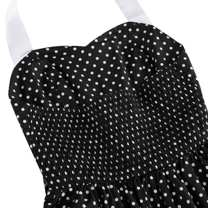 Detail of polka dot dress featuring a sweetheart neckline and white halter straps