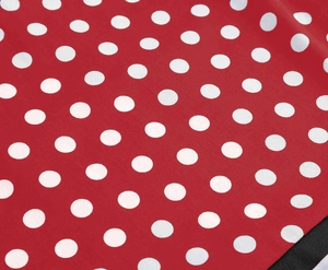 Close-up of red and white polka dot cotton fabric showing fine weave texture