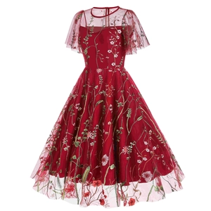 Detailed embroidery of floral patterns on dark red mesh fabric for vintage evening gown
