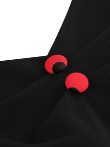 Detailed macro view of black fabric with decorative red round buttons and contrast stitching