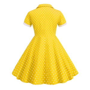 Rear view of vintage yellow girls' dress with white polka dots and A-line silhouette