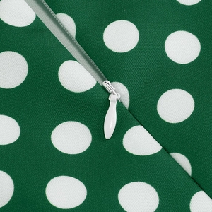 Detail of hidden zipper and high-quality twill fabric on green polka dot dress