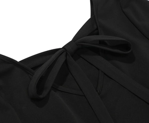 Detailed close-up of retro neckline with a bow tie on a black polka dot dress