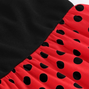 Detail of red polka dot skirt fabric joined with black plain knit bodice material
