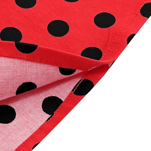 Detailed macro view of red and black polka dot fabric with premium hemmed stitching finish