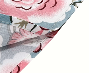 Close-up of floral print fabric showing neat double-needle stitching and smooth hem edges
