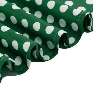 Detail of green polka dot fabric showing clean hem stitching and elegant draping