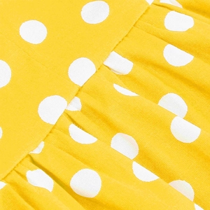Dettaglio del tessuto giallo a pois con cuciture a pieghe per abito vintage
