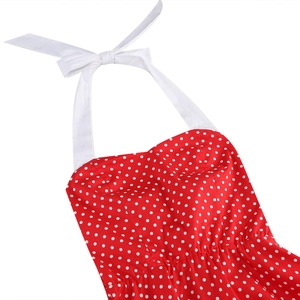 Detailed view of red polka dot dress featuring a white halter neck tie and sweetheart neckline