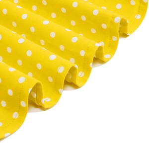 Detailed macro view of yellow polka dot fabric with refined stitching and soft texture