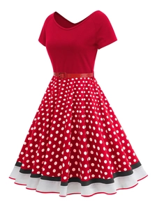 Detail of vintage V-neck red dress with polka dot skirt and white striped hemline