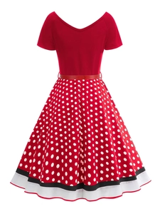 Detail of red V-neck polka dot dress featuring a striped hem and matching waist belt